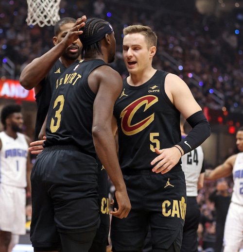 Cleveland Cavaliers guard Caris LeVert is helped up after hitting a basket and drawing a foul against the Orlando Magic in the first half of play.