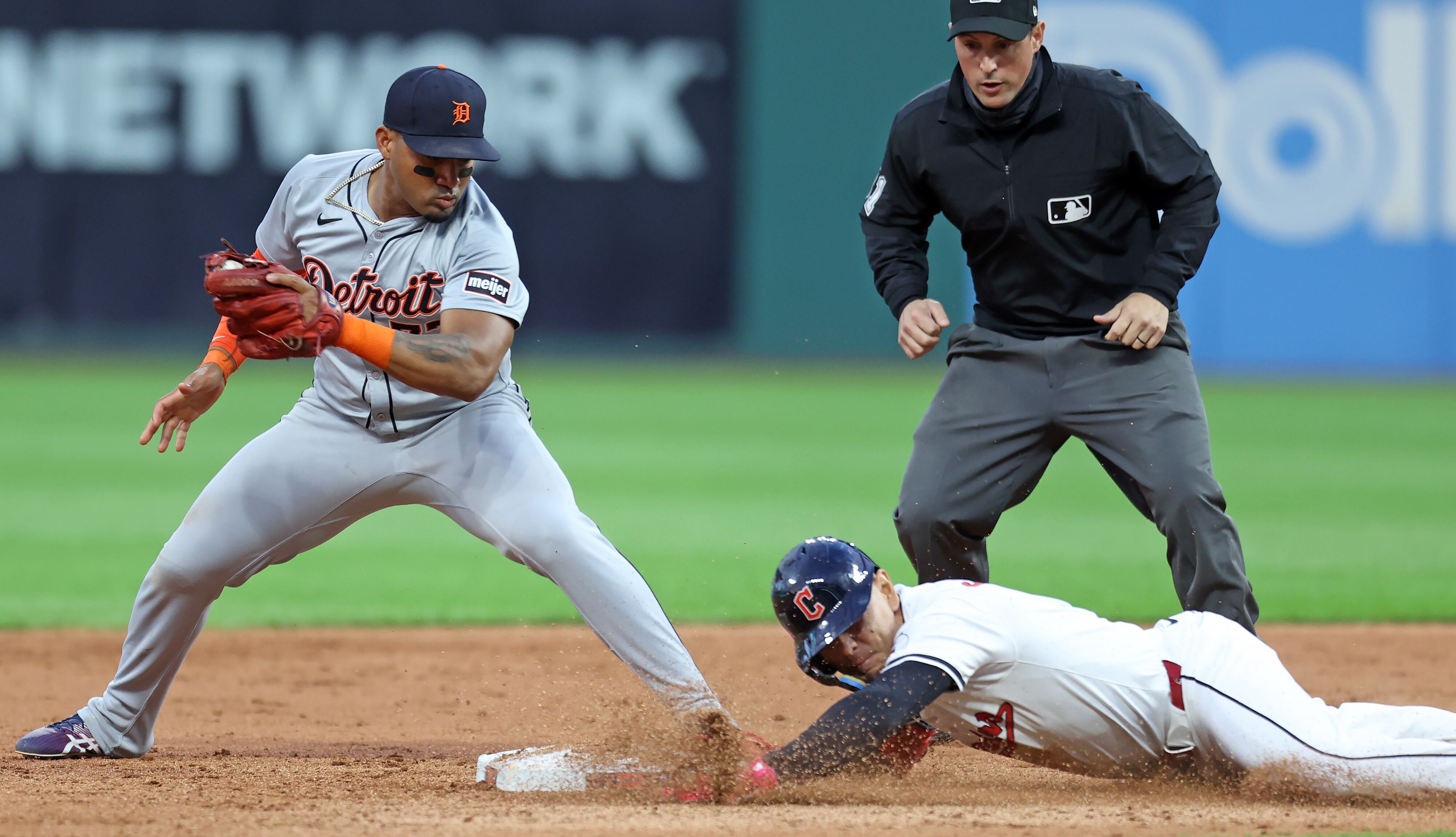 Cleveland Guardians second base Andrés Giménez slides into second after hitting a double to left field against the Detroit Tigers in the eighth inning. 
