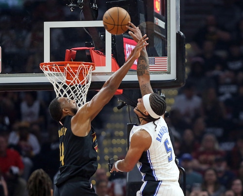 Orlando Magic forward Paolo Banchero goes up for a dunk and draws the foul from Cleveland Cavaliers forward Evan Mobley in the first half of play.